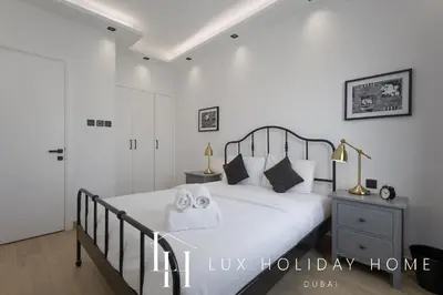 a bedroom with a bed with two towels on it at LUX The Serene Springs Villa in Dubai