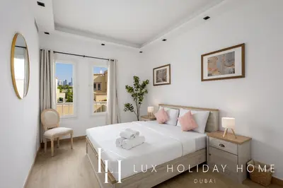 a bedroom with a bed with a teddy bear on it at LUX The Serene Springs Villa in Dubai
