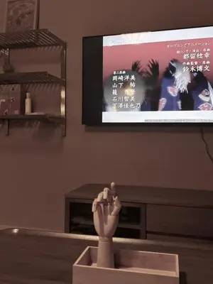 a statue of a hand in front of a tv at Modern Japanese and Arabic Fusion City Stay that is 10 min from Dubai Mall in Dubai