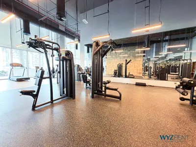 a gym with several tread machines in a room at Best Studio facing Burj Khalifa in Dubai