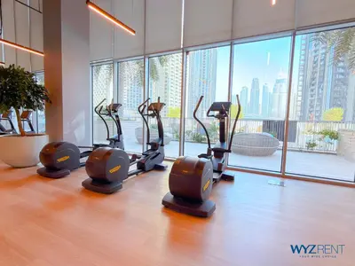 a row of cardio exercise bikes in a gym at Best Studio facing Burj Khalifa in Dubai