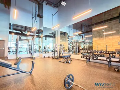 a gym with rows of exercise bikes and weights at Best Studio facing Burj Khalifa in Dubai