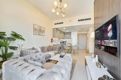 a living room with couches and a flat screen tv at Elegant 2BR Getaway in Azizi Riviera Near Downtown in Dubai