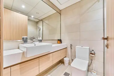 a bathroom with a sink and a toilet at Elegant 2BR Getaway in Azizi Riviera Near Downtown in Dubai