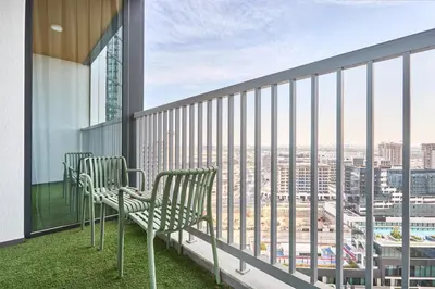 two chairs on a balcony with a view of a city at STAY BY LATINEM Luxury 1BR Holiday Home CA 1605 Near Burj Khalifa in Dubai