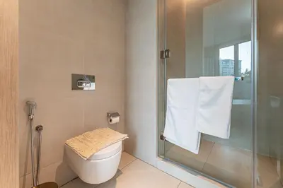 a bathroom with a toilet and a glass shower at HAVN - 3 Bedroom in The Address, JBR in Dubai