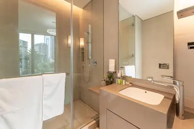 a bathroom with a sink and a shower with a mirror at HAVN - 3 Bedroom in The Address, JBR in Dubai