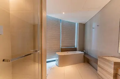 a bathroom with a toilet and a glass shower at HAVN - 3 Bedroom in The Address, JBR in Dubai