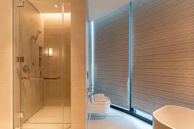 a bathroom with a shower and a toilet and a sink at HAVN - 3 Bedroom in The Address, JBR in Dubai