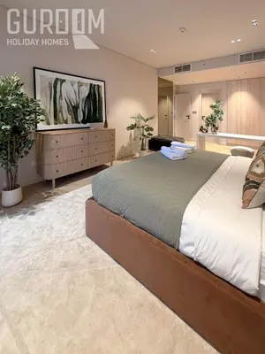 a large bedroom with a large bed and a tv at Amazing 4 BR on Palm Jumeirah with super sea view in Dubai