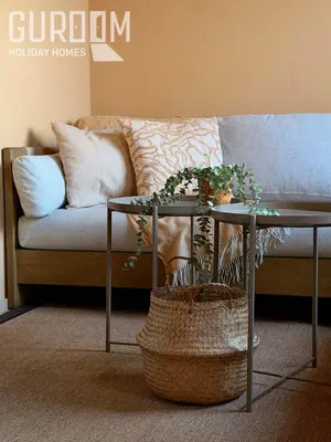 a living room with a couch and a table with plants at Amazing 4 BR on Palm Jumeirah with super sea view in Dubai