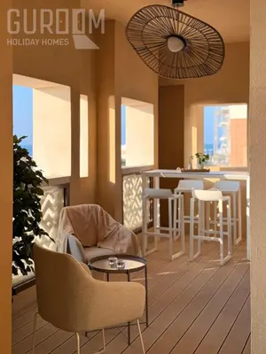 a magazine mockup of a living room and a kitchen at Amazing 4 BR on Palm Jumeirah with super sea view in Dubai