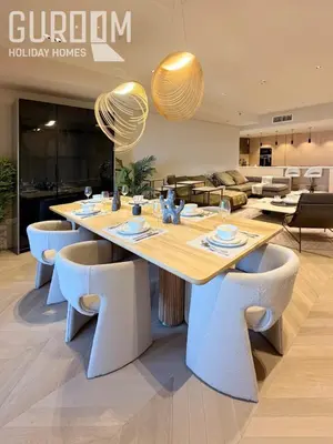 a dining room with a large table and chairs at Amazing 4 BR on Palm Jumeirah with super sea view in Dubai