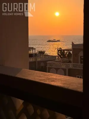 a sunset over the ocean with a cruise ship at Amazing 4 BR on Palm Jumeirah with super sea view in Dubai