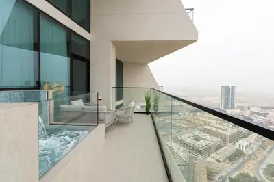 a balcony with a view of a city at Designer Apartment 34-56 with Private Jacuzzi in JVC in Dubai