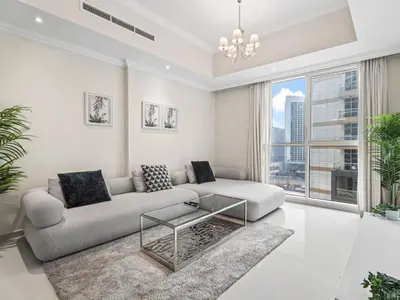 a living room with a couch and a glass coffee table at Urban Elegance 1BDR in Dunya 06 in Dubai