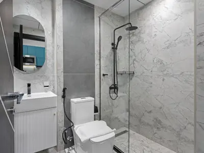 a bathroom with a shower with a toilet and a sink at Opalz Solace Cozy Luxe Studio 03 in Dubai