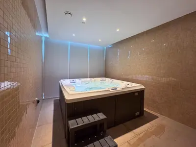 a bathroom with a jacuzzi tub in a room at Opalz Solace Cozy Luxe Studio 03 in Dubai