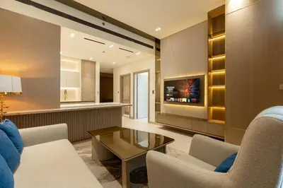 a living room with a couch and chairs and a tv at The Royal Blue Jacuzzi Suite 32 1-6-10 I JVC I Dar Oasis in Dubai