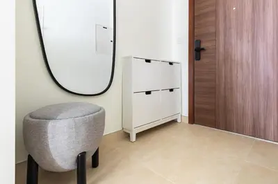a dressing room with a chair and a mirror at Downtown Dubai - Bright 1BR Apartment - Imperial Avenue in Dubai