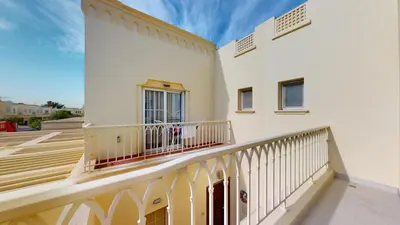 a balcony of a white house with a railing at Vacationer l Opulent 2 Bedroom Villa l Private Plunge Pool in Dubai