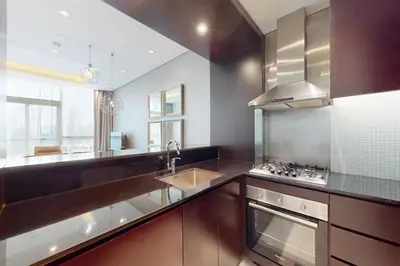 a large kitchen with a sink and a stove at Vacationer I Premium 2 Bedroom Apartment I Iconic Burj Khalifa View I Downtown I Distinction Tower in Dubai