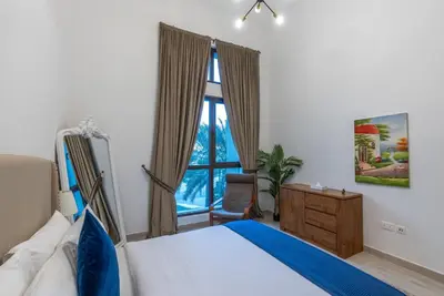 a bedroom with a bed and a window at Jumeirah Stay Near To Beach in Dubai
