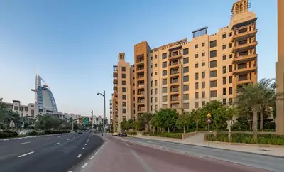 an empty street in a city with tall buildings at Jumeirah Stay Near To Beach in Dubai