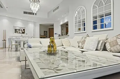 a living room with a couch and a glass table at Ultra-Luxury 3BR -Full Sea & Marina Views - JBR in Dubai