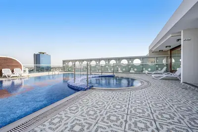 a swimming pool on the roof of a building at Amazing Studio Glitz 1 Dubai Studio city in Dubai