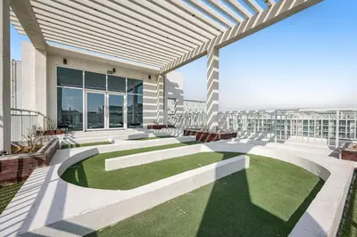a view of a building with a yard of grass at Amazing Studio Glitz 1 Dubai Studio city in Dubai