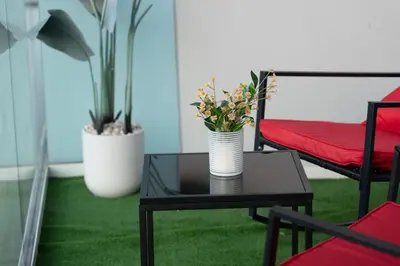 a coffee table with flowers on top of a room at Stylish 1BR Burj Khalifa Fireworks View - Reva Residence in Dubai