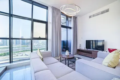 a living room with white furniture and large windows at Balcony Breeze O2 with amazing high way view in Dubai
