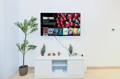 a white desk in a room with a poster on the wall at Bloomfields Comfort Studio at Bali Residence, DXB in Dubai