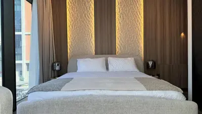a bedroom with a large bed and a window at Huge Luxury Waterfront Duplex in Peninsula 5 in Dubai