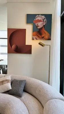 a living room with a couch and a painting on the wall at Huge Luxury Waterfront Duplex in Peninsula 5 in Dubai