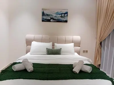 a large white bed with two pillows on it at The Executive Suite Luxury 1 Bedroom Brand New in Dubai