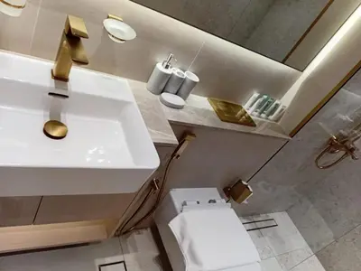 a bathroom with a sink and a toilet at The Executive Suite Luxury 1 Bedroom Brand New in Dubai