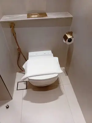 a bathroom with a white toilet with a counter at The Executive Suite Luxury 1 Bedroom Brand New in Dubai