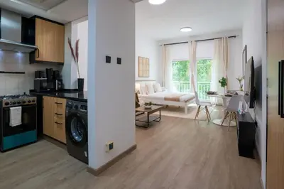 a kitchen and living room with a washer and dryer at Airstay - Upgraded Studio - Near Pool & Metro - Monthly Offer Available! in Dubai