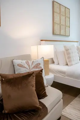 a living room with a white couch and a white couch at Airstay - Upgraded Studio - Near Pool & Metro - Monthly Offer Available! in Dubai