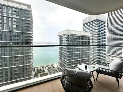 a room with a large window with a view of the city at Sea View Apartment at Emaar Beachfront by KeyRock in Dubai