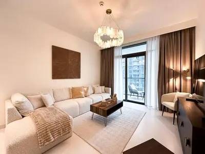 a living room with a couch and a table at Sea View Apartment at Emaar Beachfront by KeyRock in Dubai