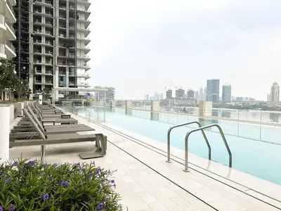 a swimming pool on the roof of a building at Sea View Apartment at Emaar Beachfront by KeyRock in Dubai