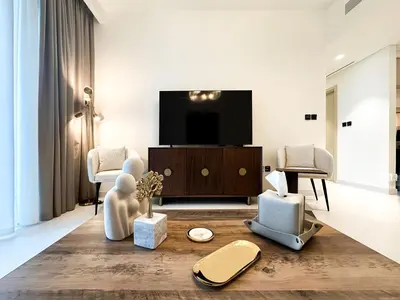 a living room with a flat screen tv and furniture at Sea View Apartment at Emaar Beachfront by KeyRock in Dubai