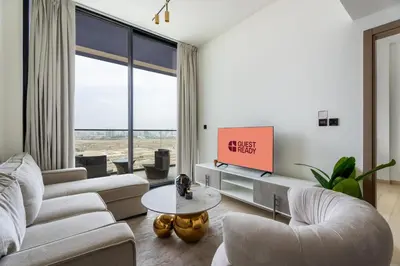 a living room with two couches and a tv at GuestReady- Comfortable 1 bedroom- High Floor in Dubai