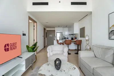 a living room with a couch and a table at GuestReady- Comfortable 1 bedroom- High Floor in Dubai