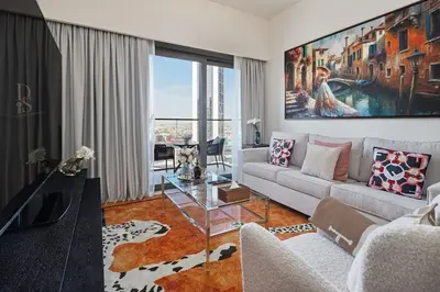 a living room with a couch and a table at Stylish 1BR, Walk to Burj Khalifa and Dubai Mall in Dubai