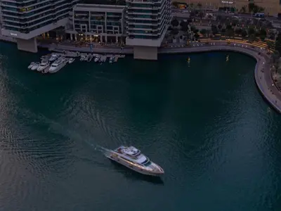 a boat in the water next to some buildings at Luxury Views at The Address Dubai Marina in Dubai