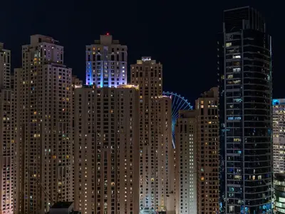 a group of tall buildings in a city at night at Luxury Views at The Address Dubai Marina in Dubai